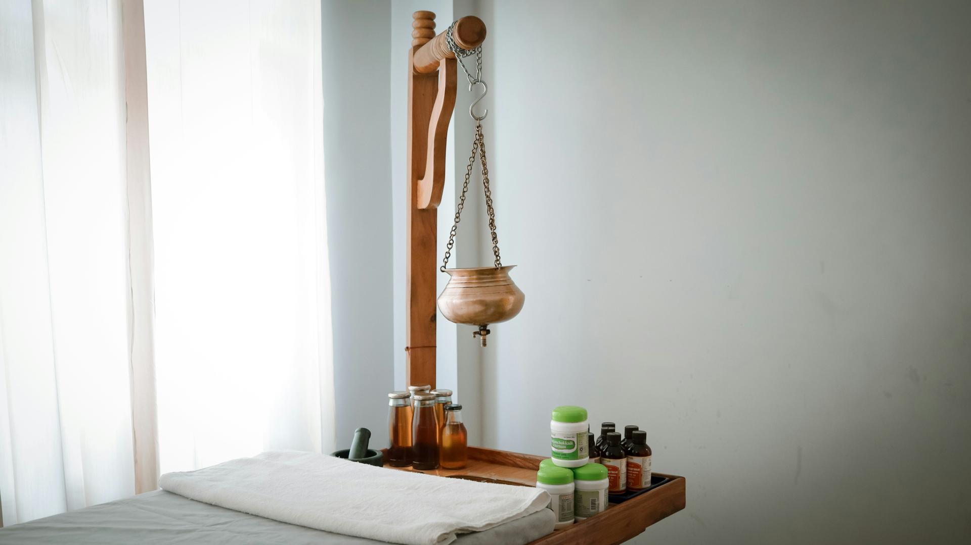 Herbal oil massage therapy room with traditional Ayurvedic treatment table